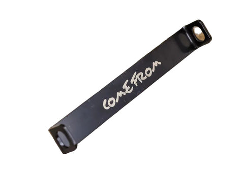 Black strap with 'Cone From' text on a wooden surface